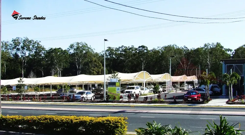 Double cantilever shades providing extensive vehicle coverage