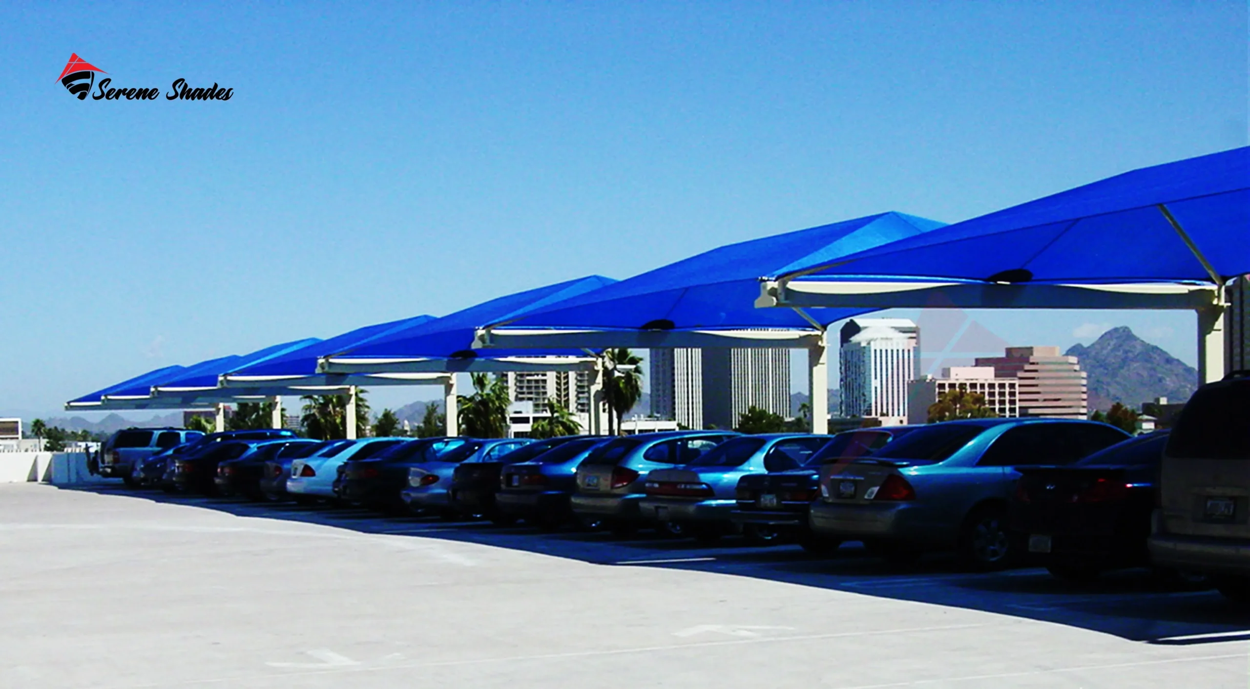 Mesh parking shade covering multiple car spaces