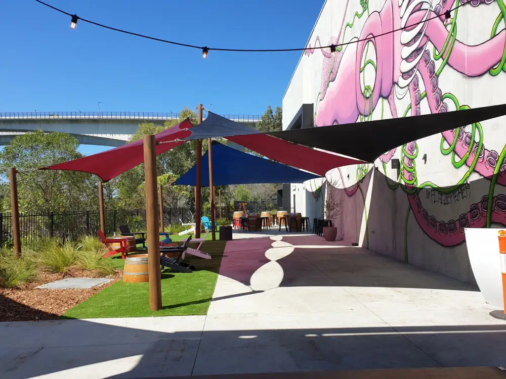 Overlapping Sail Shades enhancing a modern patio with unique design